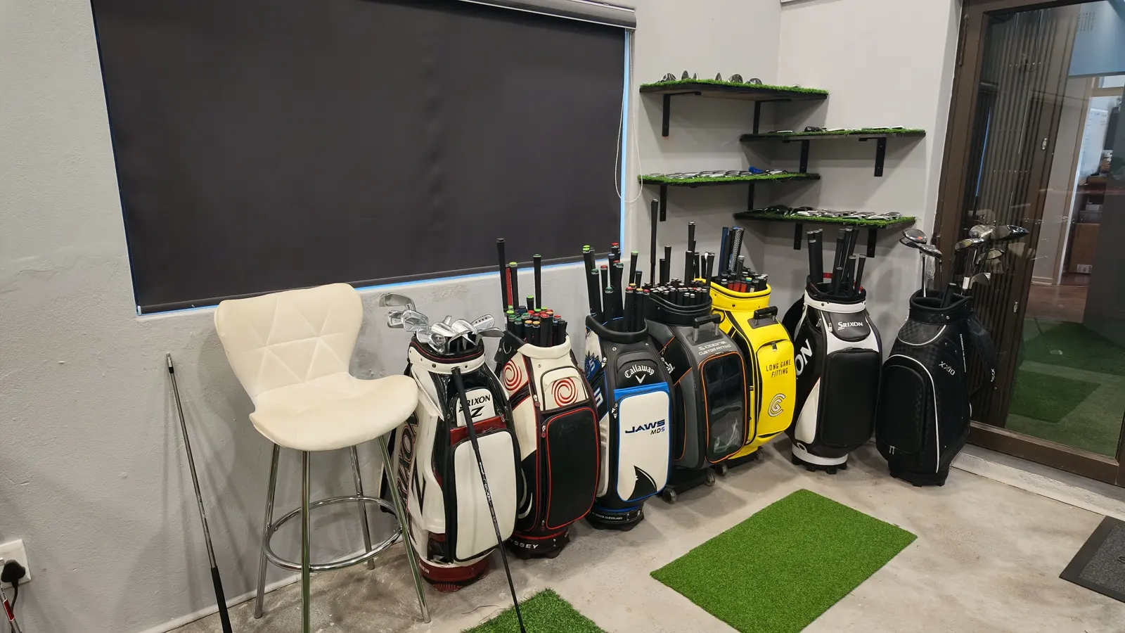 The consultation corner at Golf Concepts, with tour bags lined along the wall