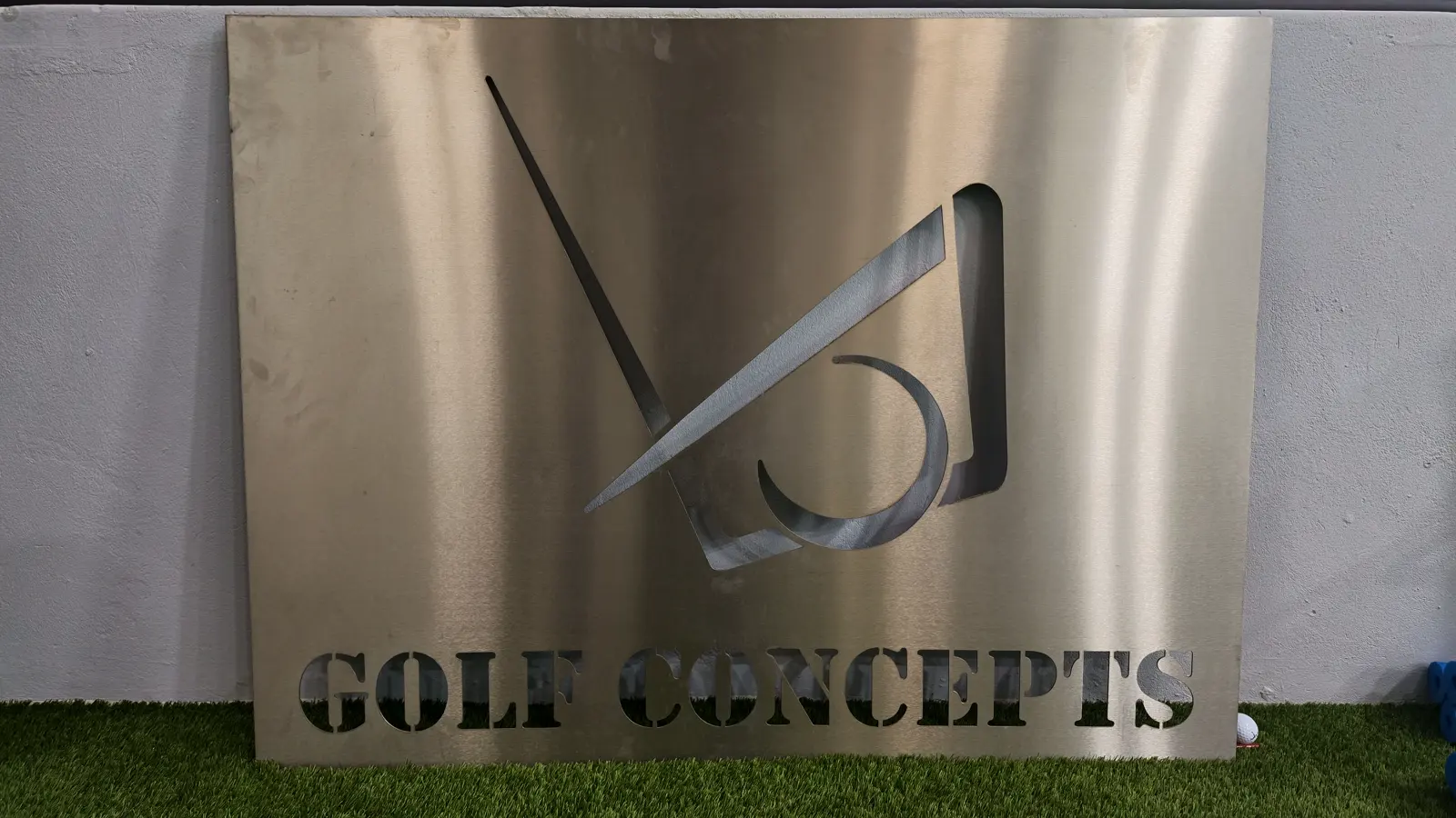 The brushed steel Golf Concepts sign outside the premises in Dowerglen