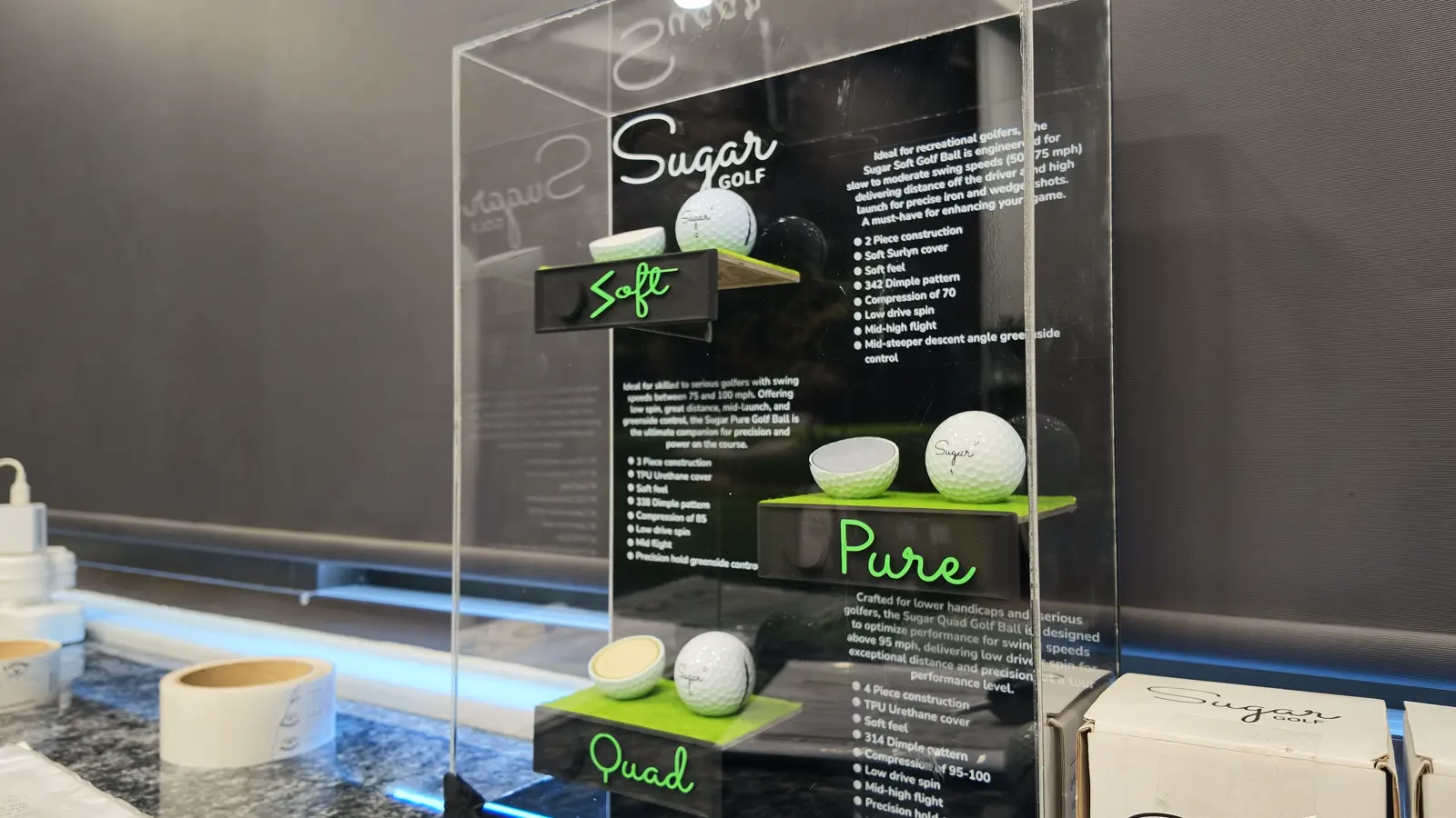 The Sugar Golf ball display case at Golf Concepts, showing the Soft, Pure and Quad cutaways